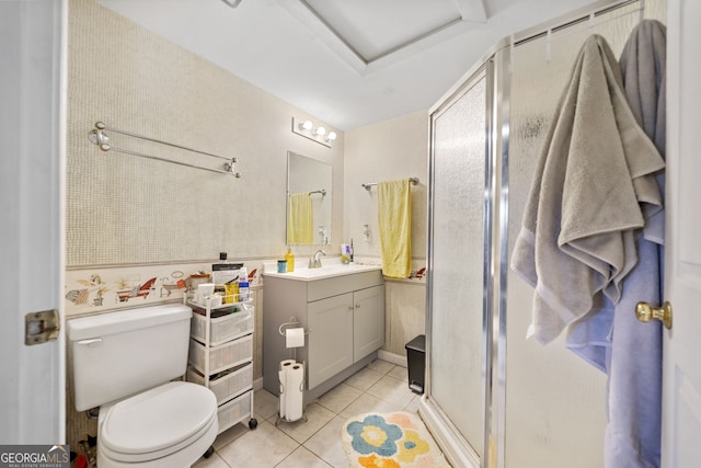 bathroom featuring tile patterned floors, vanity, toilet, and a shower with shower door