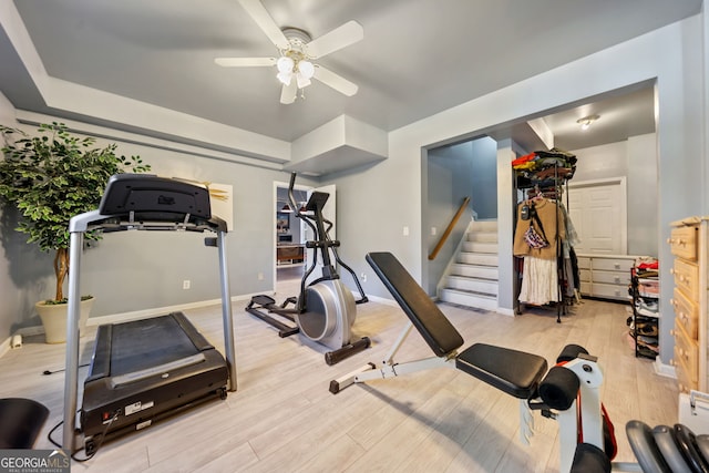 exercise room featuring light hardwood / wood-style flooring and ceiling fan