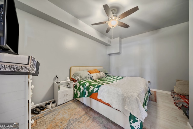 bedroom with hardwood / wood-style floors and ceiling fan