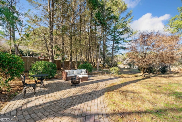 view of yard with a patio and an outdoor living space with a fire pit