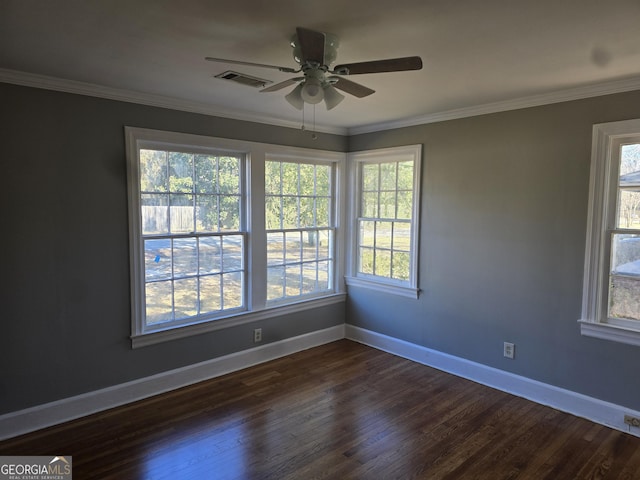 empty room with ceiling fan, dark hardwood / wood-style floors, and ornamental molding