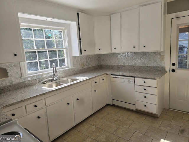 kitchen featuring white dishwasher, white cabinets, sink, light stone countertops, and light tile patterned flooring