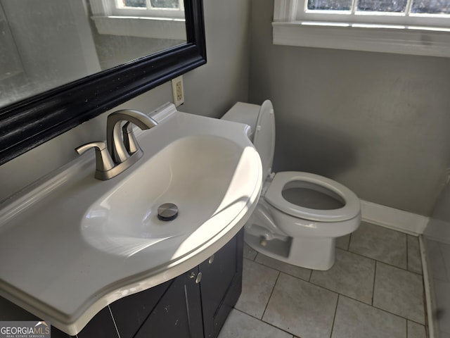 bathroom featuring toilet, vanity, and tile patterned floors