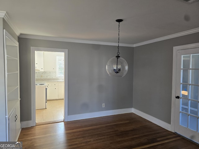 unfurnished dining area with dark wood-type flooring, an inviting chandelier, and ornamental molding