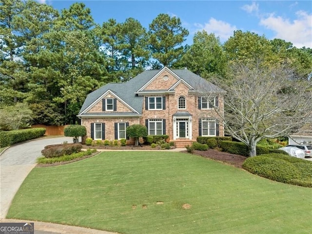 colonial inspired home with a front yard