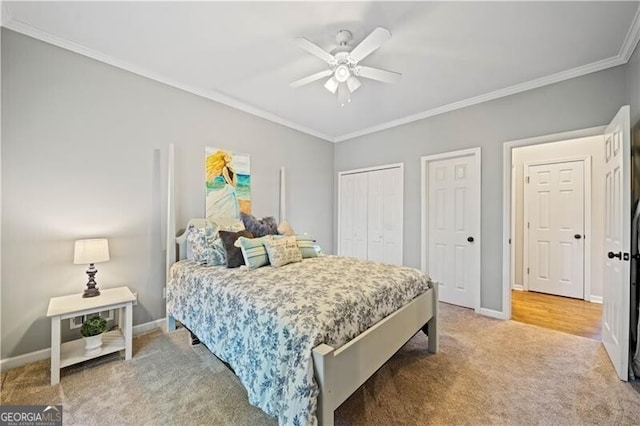 carpeted bedroom featuring a closet, ceiling fan, and crown molding