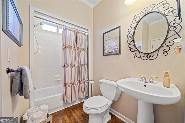 bathroom with toilet, shower / bath combo with shower curtain, hardwood / wood-style floors, and ornamental molding