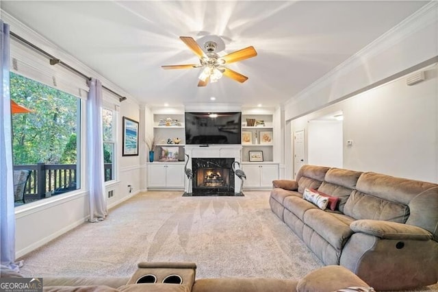 living room with a fireplace, light colored carpet, built in features, and ornamental molding