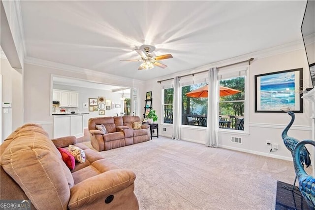 carpeted living room featuring ceiling fan and crown molding