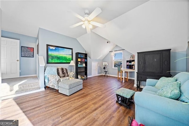 living room featuring ceiling fan, hardwood / wood-style floors, and vaulted ceiling