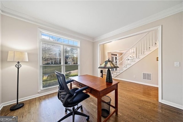 office space featuring hardwood / wood-style floors and crown molding