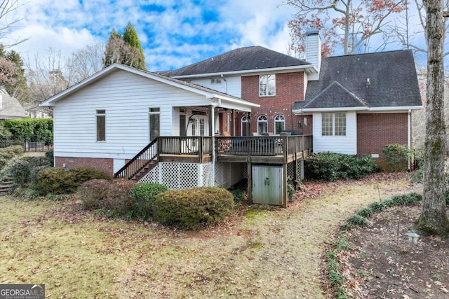 back of house featuring a deck