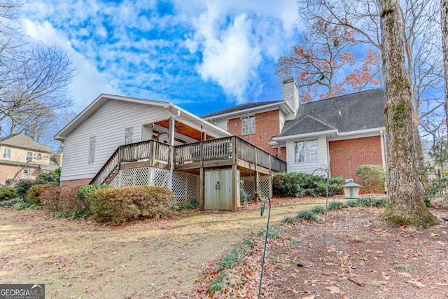 back of property featuring a wooden deck