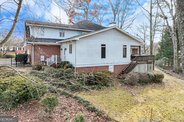 view of side of home featuring a deck