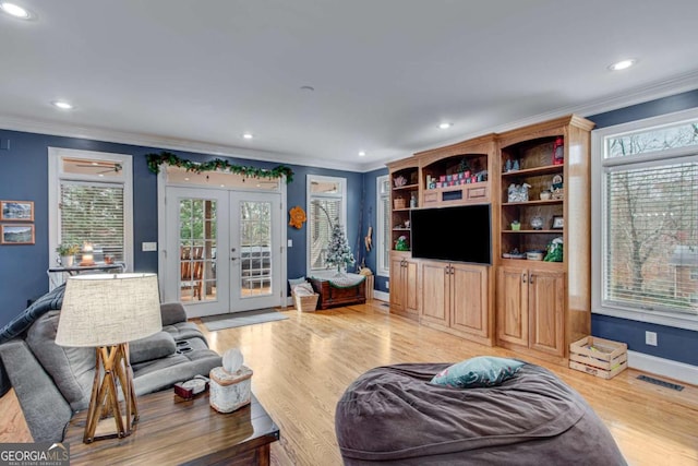 living room with french doors, light wood-type flooring, and ornamental molding