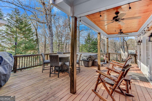 wooden terrace featuring ceiling fan and grilling area