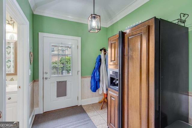 doorway to outside with crown molding and light tile patterned flooring