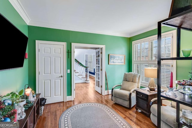 sitting room with crown molding and hardwood / wood-style flooring