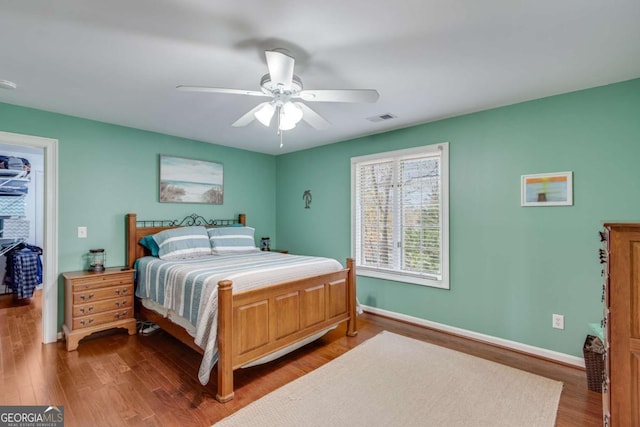 bedroom featuring ceiling fan and dark wood-type flooring