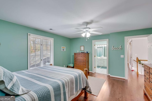 bedroom featuring hardwood / wood-style flooring, ceiling fan, and ensuite bathroom