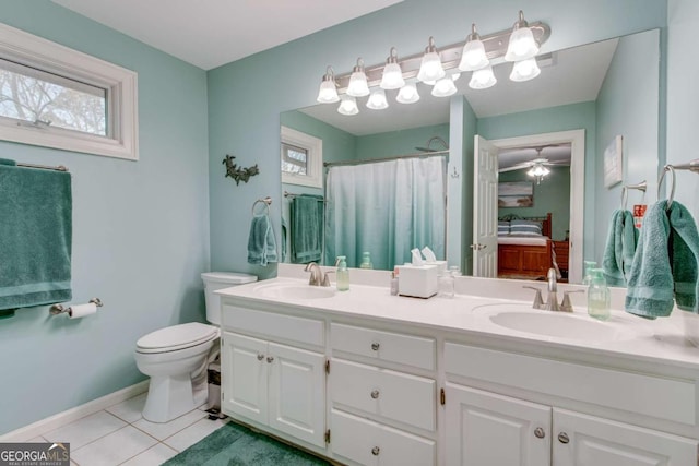 bathroom with vanity, tile patterned flooring, ceiling fan, a shower with shower curtain, and toilet