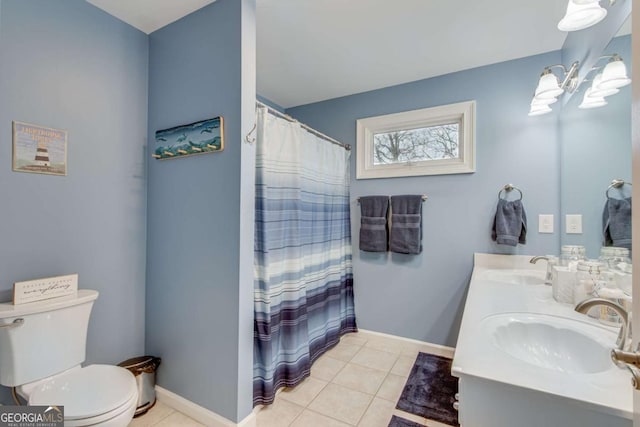 bathroom featuring tile patterned floors, vanity, curtained shower, and toilet