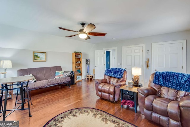 living room featuring wood-type flooring and ceiling fan