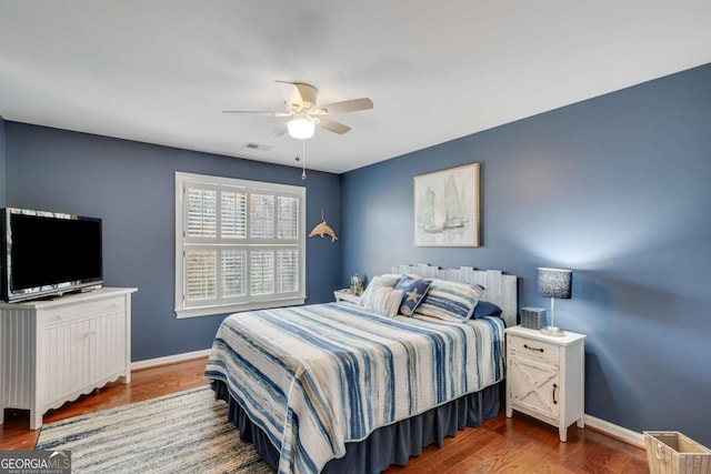 bedroom with hardwood / wood-style flooring and ceiling fan