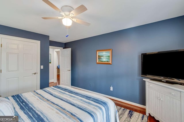 bedroom with ceiling fan and hardwood / wood-style floors