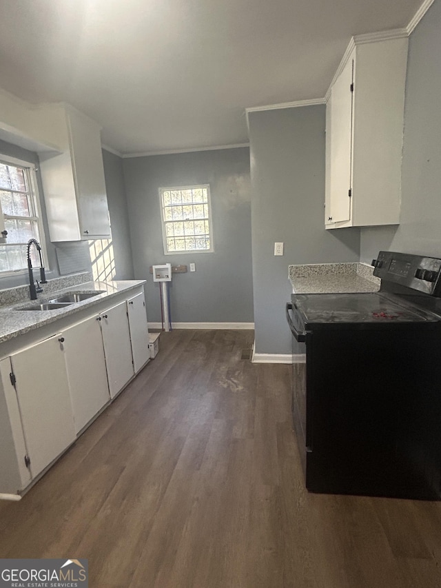 kitchen with white cabinetry, sink, black electric range oven, dark hardwood / wood-style floors, and ornamental molding