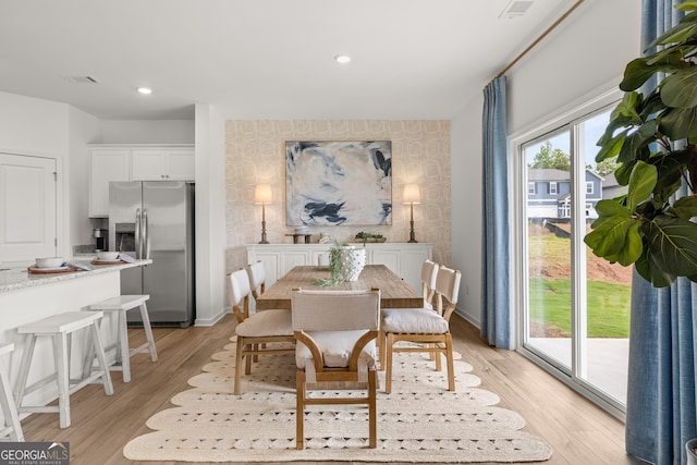 128 Rolling Meadow Way, Kathleen, GA 31047 - dining space featuring an accent wall, light wood-style floors, recessed lighting, wallpapered walls, and baseboards