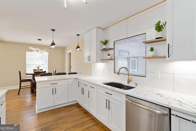 kitchen featuring kitchen peninsula, sink, stainless steel dishwasher, ceiling fan, and white cabinetry