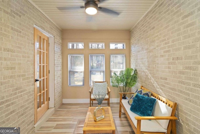 sunroom featuring french doors and ceiling fan