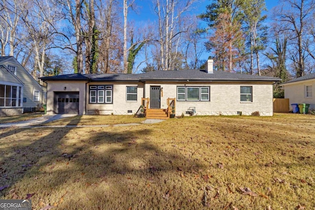 ranch-style home with a garage and a front yard