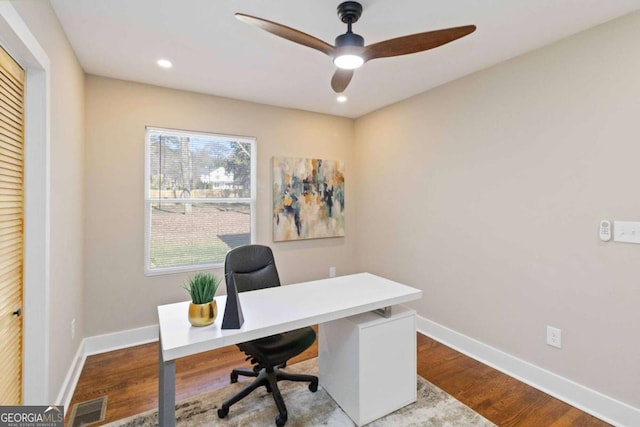 home office with light hardwood / wood-style floors and ceiling fan