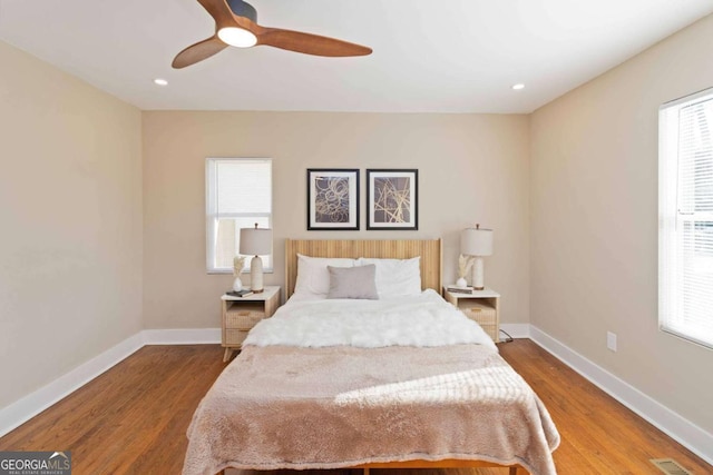 bedroom with ceiling fan and hardwood / wood-style flooring