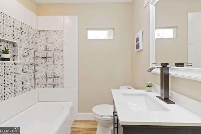 bathroom featuring vanity, hardwood / wood-style flooring, toilet, and a wealth of natural light