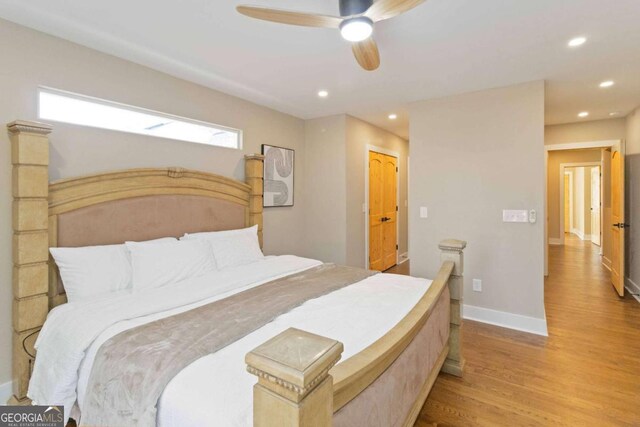 bedroom with ceiling fan and dark hardwood / wood-style floors