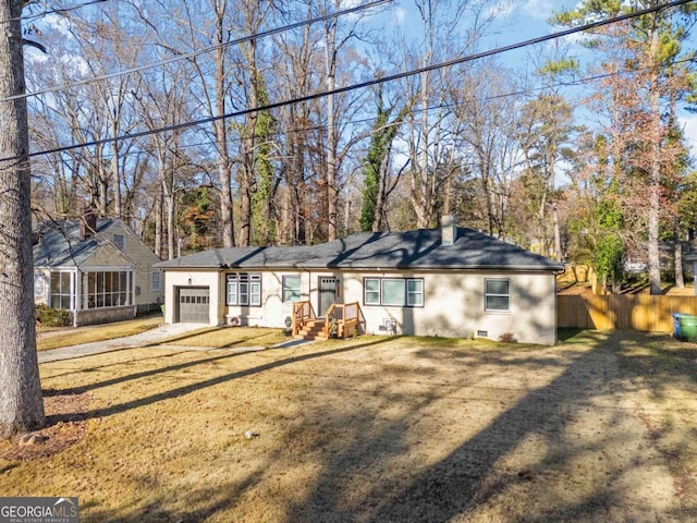 back of property with a lawn and a garage