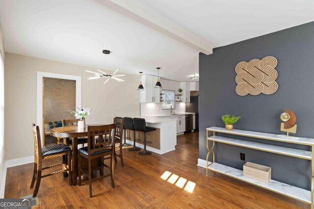 kitchen with stainless steel appliances, white cabinetry, tasteful backsplash, and sink