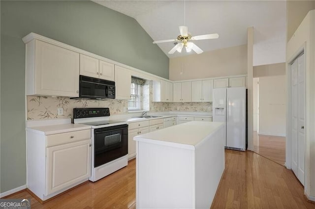 kitchen with white cabinets, decorative backsplash, white appliances, and a center island