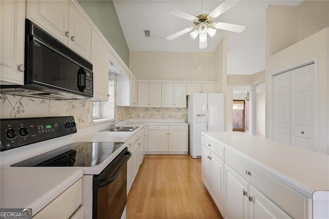 kitchen featuring white cabinets, sink, ceiling fan, range with electric stovetop, and white fridge with ice dispenser