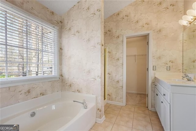 bathroom featuring tile patterned flooring, vanity, and a bathing tub