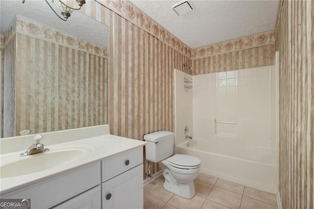 full bathroom with tile patterned flooring, a textured ceiling, toilet, vanity, and bathtub / shower combination