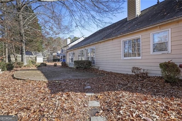 view of property exterior with a patio area