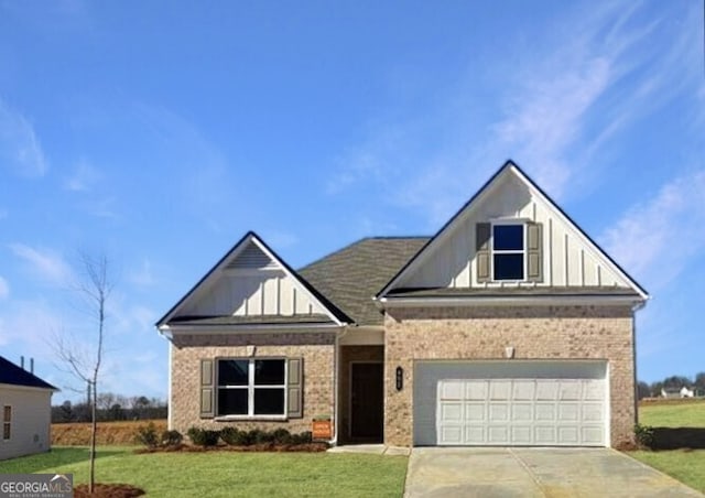 view of front of home featuring brick siding, concrete driveway, an attached garage, board and batten siding, and a front yard