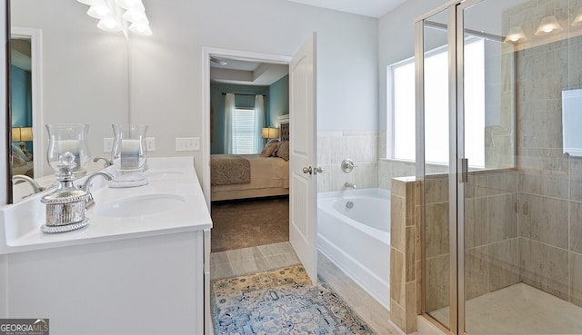 ensuite bathroom featuring ensuite bathroom, a sink, tile patterned flooring, a shower stall, and a bath