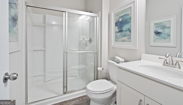 full bath featuring a shower stall, toilet, and vanity