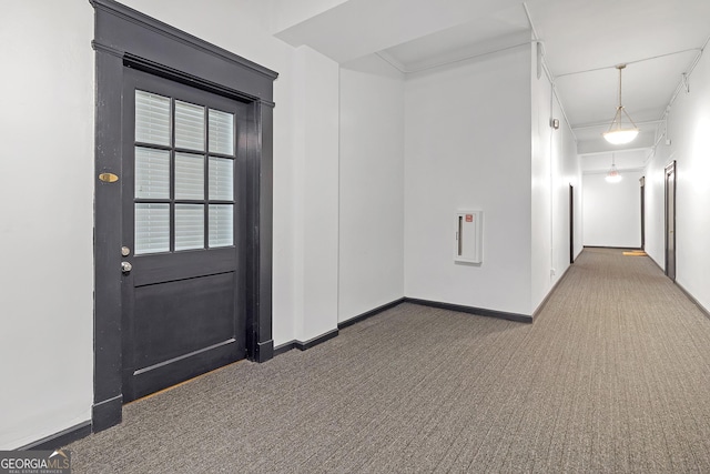 interior space featuring dark colored carpet and ornamental molding