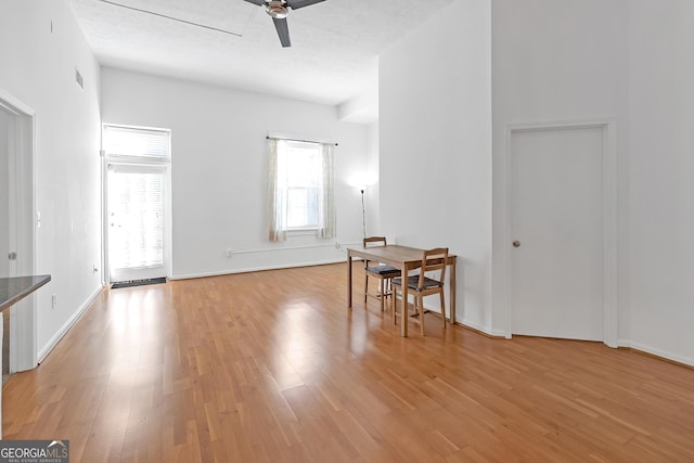 dining space with light hardwood / wood-style flooring and ceiling fan